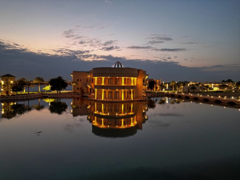 Image of AUIB Campus at dusk reflected in lake.